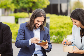 Business Professionals Enjoying a Casual Lunch Break Outdoors