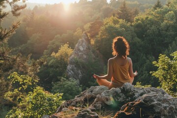 Woman meditating outdoor in the nature under the bright sunlight