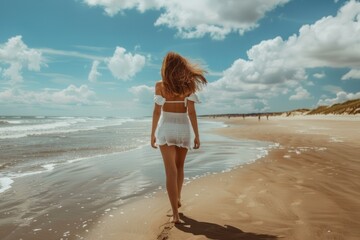 young woman walks on beach alone back view copy space