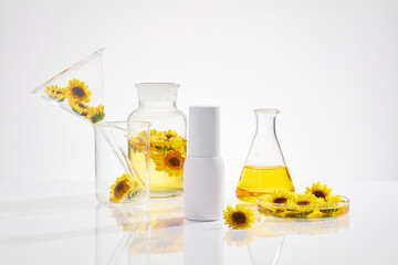 Laboratory background has many types of equipment and calendula composition with a unlabeled bottle...