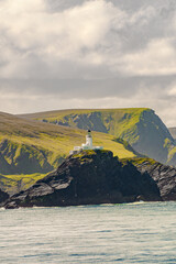 Muckle Flugga lighthouse Shetland, Scotland. Cover page with gorgeous sunset over fjords landscape...