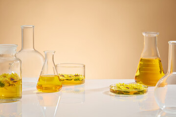 Light brown background against some lab equipments neatly arranged on white table with pure...