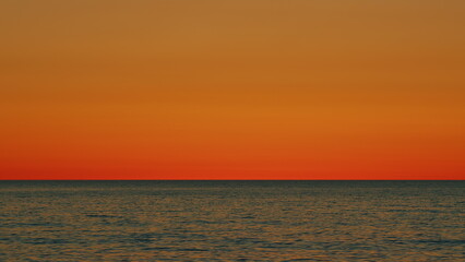 Naklejka premium Amazing Scene Sunset Tropical Sea. Bright Sun Over Sea. Sunrise Over Sea. Golden Shimmering Sea Waves In Sun. Slow motion.