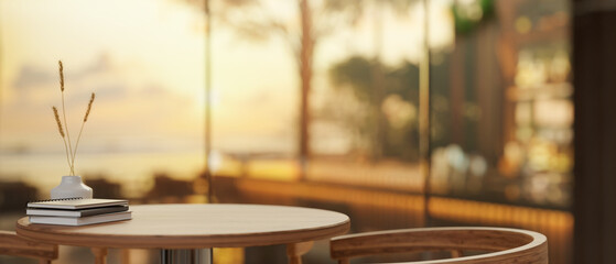 A wooden table in a beautiful contemporary hotel lounge or restaurant with a beautiful sunset view.