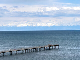 Fototapeta premium Sunny summer day on the lake. Mountains and sea. Kyrgyzstan, Lake Issyk-Kul