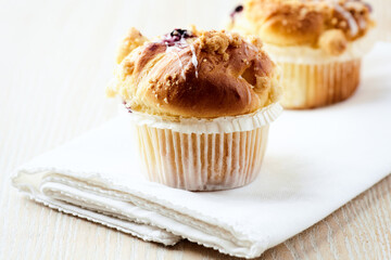 Muffins on bright wooden background. Close up. Copy space.
