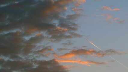 Jet Plane Aircraft With Contrails. Long Trail Of Jet Plane On Sunset Orange Sky Background. Still.