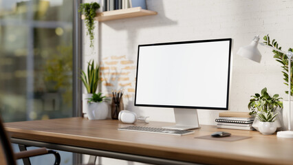 A contemporary minimalist home office features a computer mockup against a white rustic brick wall.