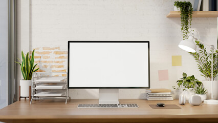 A contemporary minimalist home office features a computer mockup against a white rustic brick wall.