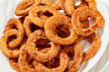 deep fried crispy onion rings on white plate