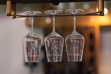 Luxury wine and champagne glasses hanging up side down in the pub