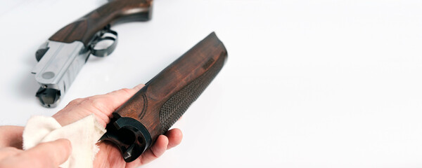 The forend of a hunting double-barreled shotgun should be wiped with a clean rag to remove excess...