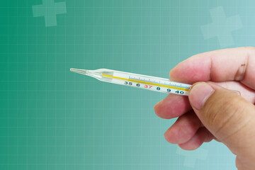 Hand holding a thermometer Measure body temperature,5 basic medical vital signs, vital signs monitoring, vital signs monitor,Health service concept and medical technology.