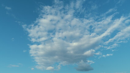 Sunny And Windy Weather Sky With Blue Tones. Cloud Is Aerosol Comprising Visible Mass Of Liquid Droplets.