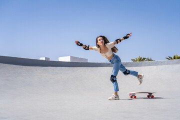 Young Woman Skateboarding on Ramp