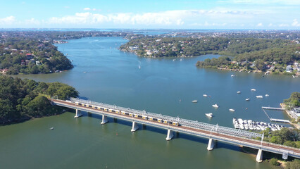 Aerial drone view of Como Bridge on the Georges River in southern Sydney, Australia showing a train...