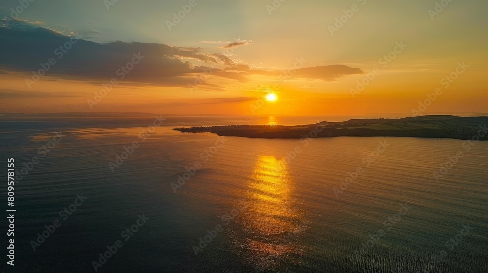 Wall mural sunset helicopter tour over the ocean with a stunning view of the shining sun, dark clouds, and orange sky, reflected in the calm waters