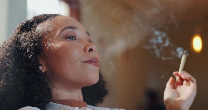 Woman, relax and smoking weed in home with cannabis, joint or cigarette with calm mindset. Smoke, marijuana and person with depression and addiction to THC, drugs and unhealthy routine or habit