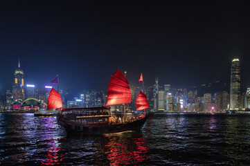 Naklejka premium Hong Kong City Skyline and Victoria Harbour with Junk Boats and Ferry