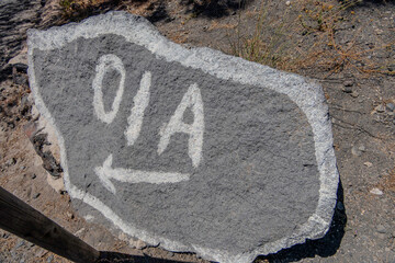 Santorini, Greece, May 3, 2024. Arrow indicating the direction of Oia on the hiking path between...
