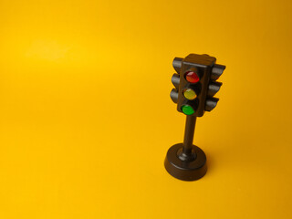 Mini traffic lights traffic lights toy on a yellow background