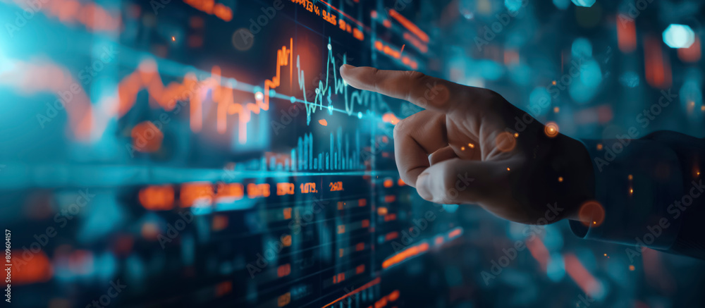 Poster banner, a hand pointing at a graph on a computer monitor screen. the graph is filled with numbers an