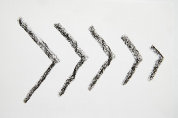 Many graceful smooth Hand drawn black chalk arrows. The concept of business, choosing direction, moving forward. Abstract sign, background, texture. Blurred