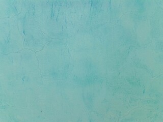 Сoncrete of blue plastered wall. Bright blue plastered wall texture grunge background. Beautiful decorative sky blue plastered wall or cyan painted stucco. Blue plastered wall as handmade rough paper