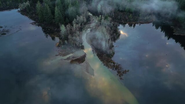 Aerial view of Secluded Scenic Lake and Foggy Trees at Sunrise. Summer Season. Port Renfrew, Vancouver Island, BC, Canada.