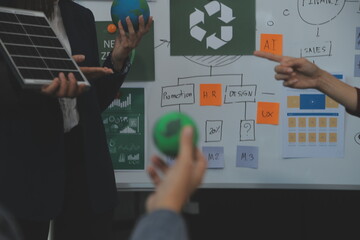 Business people having consultation about wind energy at company office. Business team discussing about windmill and alternative green energy. Executive meeting at modern office