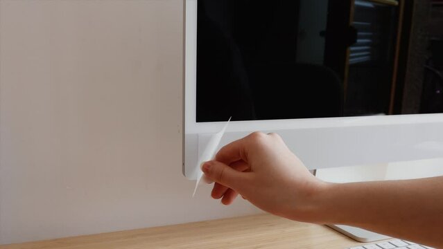 Girl Putting A Sticker On Her Work Computer