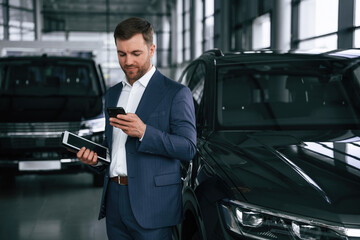 A businessman is in a car dealership