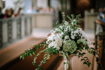 Valmiera, Latvia - August 25, 2023 - Floral arrangement featuring white flowers and green leaves on...