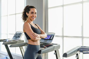woman sportwear exercise running treadmill fitness in gym health club. sportswoman slim motivation...