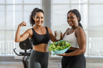 Portrait healthy women African American plus-size and Latina women with vegetable salad and milk....