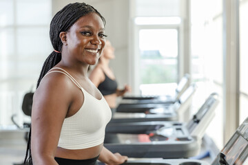 Healthy strong female African American plus-size sportswear exercise running treadmill fitness in gym health club. sportswoman slim motivation run fitness calories burn.
