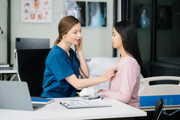 Portrait of female doctor explaining diagnosis to her patient. Doctor Meeting With Patient In Exam Room.