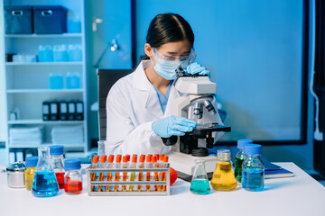 Female scientist working with micro pipettes analyzing biochemical samples, advanced science...