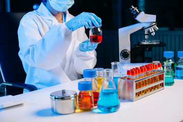 Scientist mixing chemical liquids in the chemistry lab. Researcher working