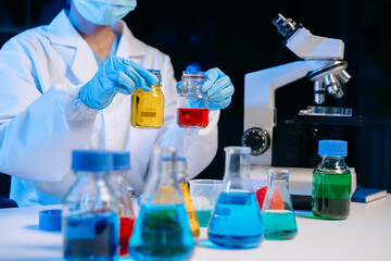 Fototapeta premium Scientist mixing chemical liquids in the chemistry lab. Researcher working