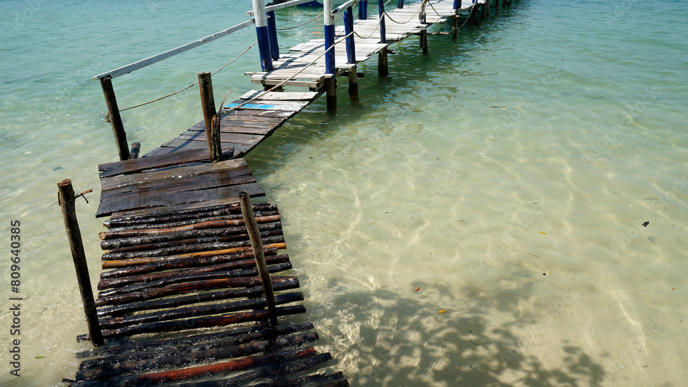 Wall mural wooden jetty on starfish beach