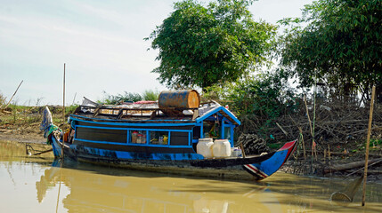 wooden boat on the tonle sap river in cambodia