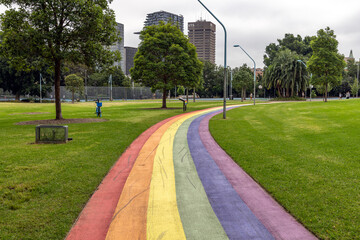 Landscape view with a rainbow coloured path, winding through a public park, in Sydney, Australia. This celebrates diversity in the community, symbolising gay pride concepts.