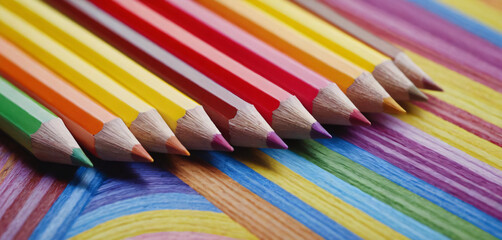 Color pencils on colored rainbow background