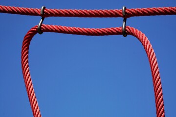 Red thin rope against the blue sky