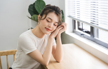 Fototapeta premium Portrait of beautiful young Asian girl at home