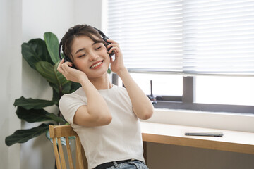 Portrait of beautiful young Asian girl at home