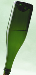 green crystal bottle rotated upside down