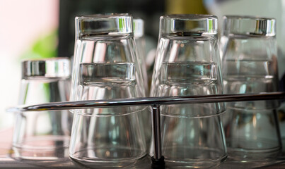 Lots of glass cups on bar counter in the foreground