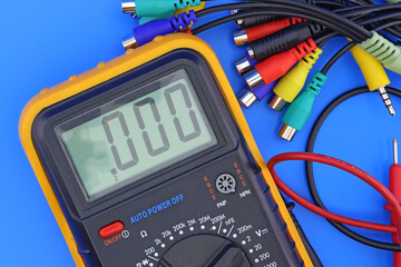 A digital multimeter for measuring the parameters of electrical circuits in an electrical diagram. Close-up.